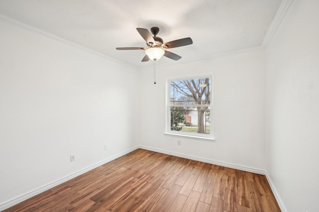 spare room with hardwood / wood-style flooring, crown molding, and ceiling fan