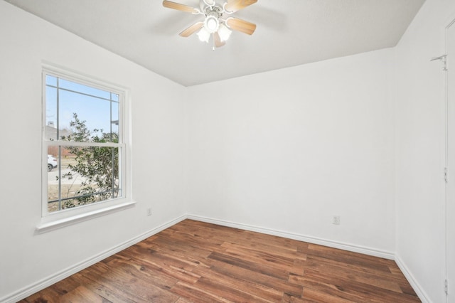 spare room featuring ceiling fan and dark hardwood / wood-style flooring