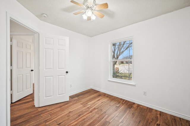 unfurnished bedroom featuring a closet, ceiling fan, and dark hardwood / wood-style flooring