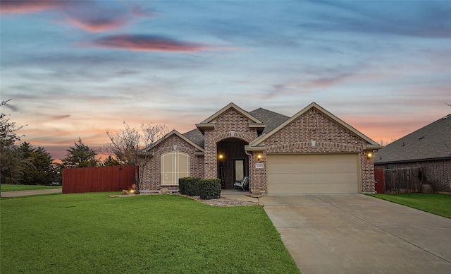 view of front of house with a garage and a lawn