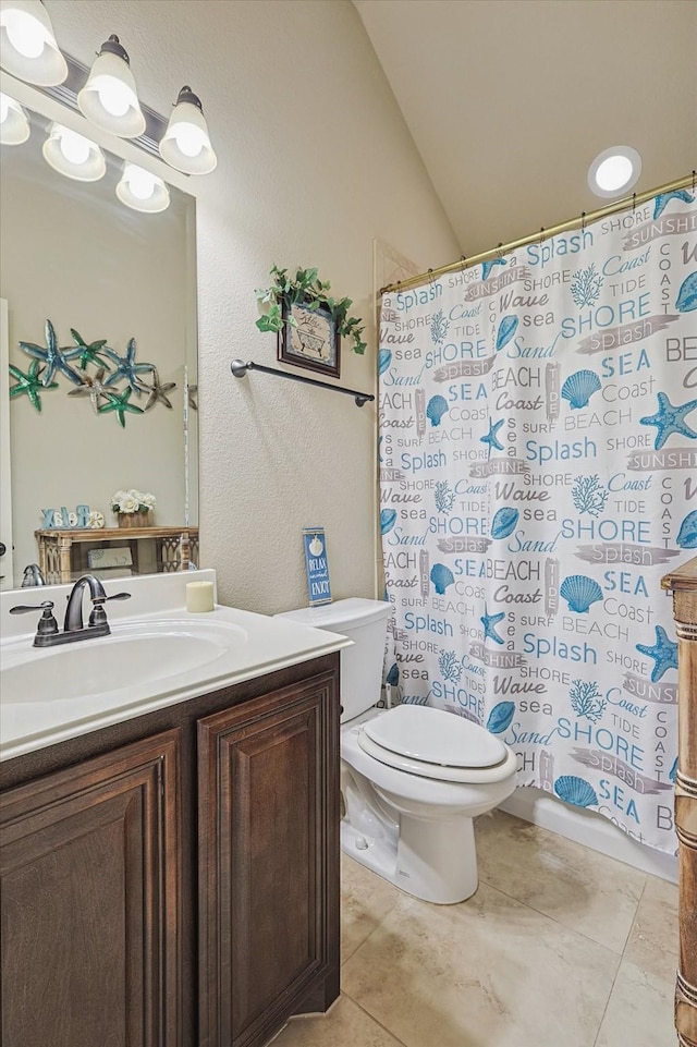 bathroom with lofted ceiling, tile patterned flooring, vanity, toilet, and a shower with shower curtain