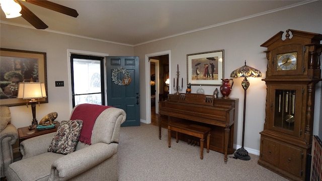 sitting room featuring light carpet, ceiling fan, and ornamental molding