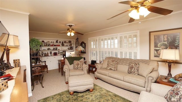 carpeted living room featuring ceiling fan and ornamental molding