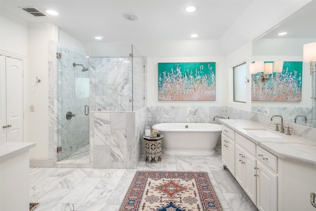 full bathroom with visible vents, a shower stall, a soaking tub, marble finish floor, and vanity