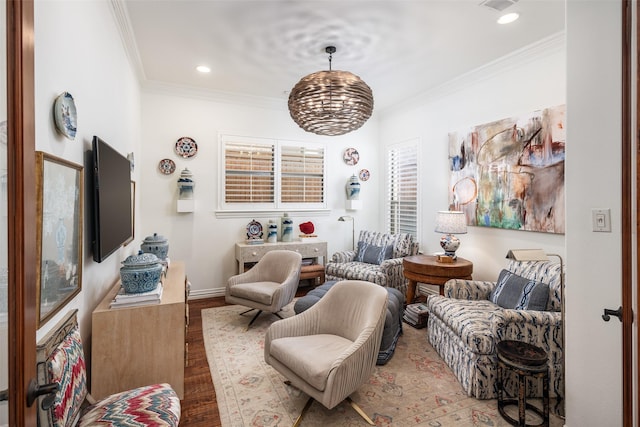 sitting room featuring recessed lighting, crown molding, baseboards, and wood finished floors