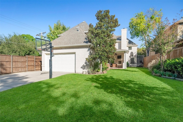 back of house featuring stucco siding, fence, a yard, concrete driveway, and a garage