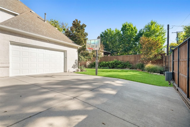 exterior space featuring concrete driveway and fence