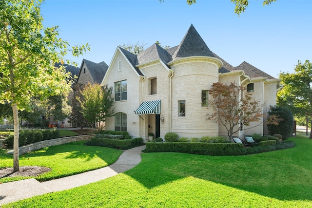 view of front of house featuring stone siding, stucco siding, and a front yard