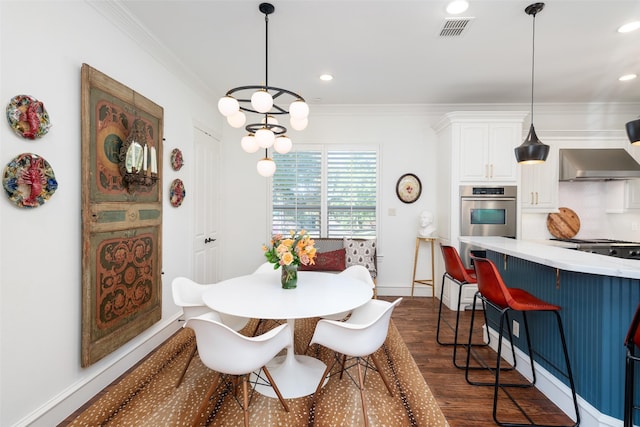 dining room with visible vents, dark wood finished floors, baseboards, ornamental molding, and recessed lighting