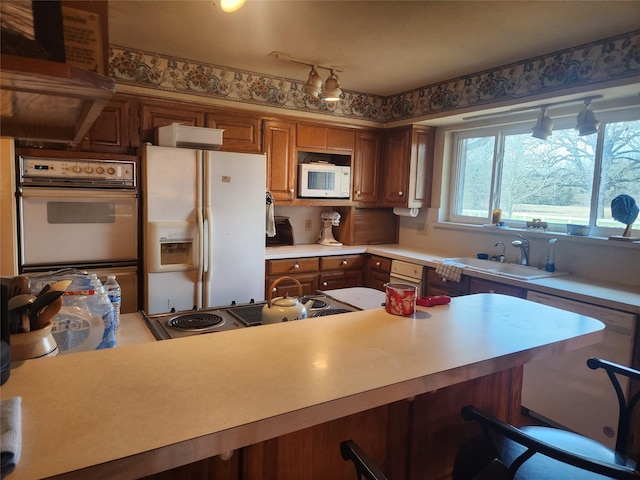 kitchen featuring sink and white appliances