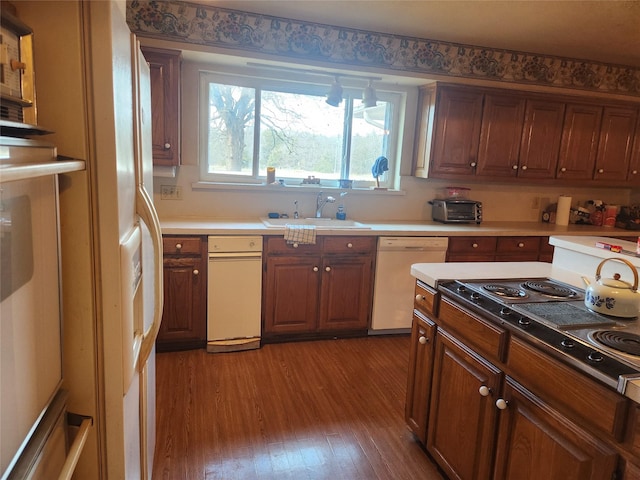 kitchen with sink, hardwood / wood-style floors, refrigerator with ice dispenser, and white dishwasher