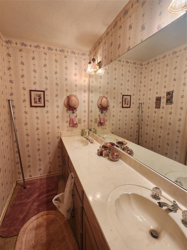 bathroom with a textured ceiling and vanity