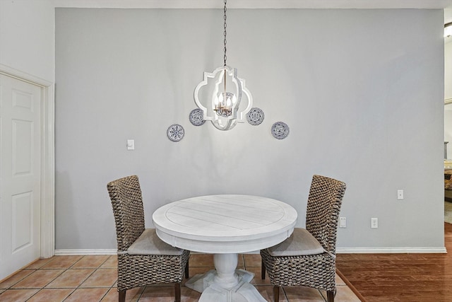 tiled dining area with a notable chandelier