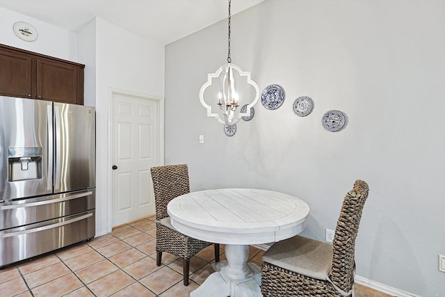 dining area with light tile patterned floors and a notable chandelier