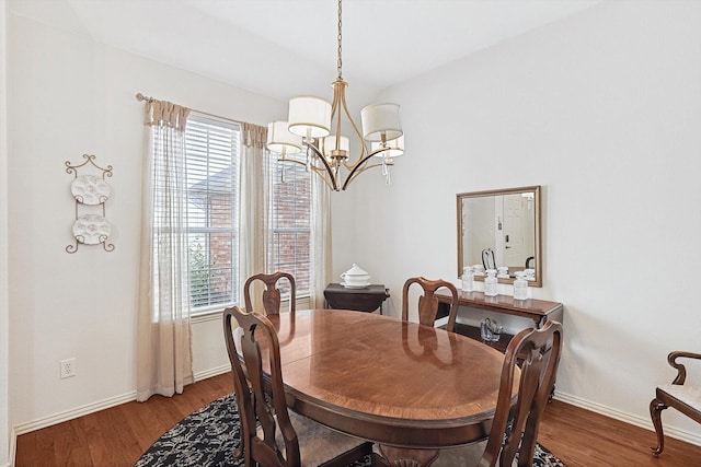 dining room featuring hardwood / wood-style floors and a notable chandelier