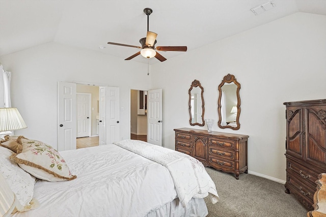 carpeted bedroom with ceiling fan and vaulted ceiling