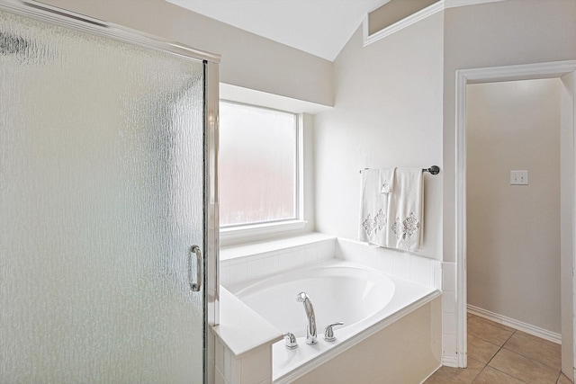 bathroom with independent shower and bath and tile patterned floors