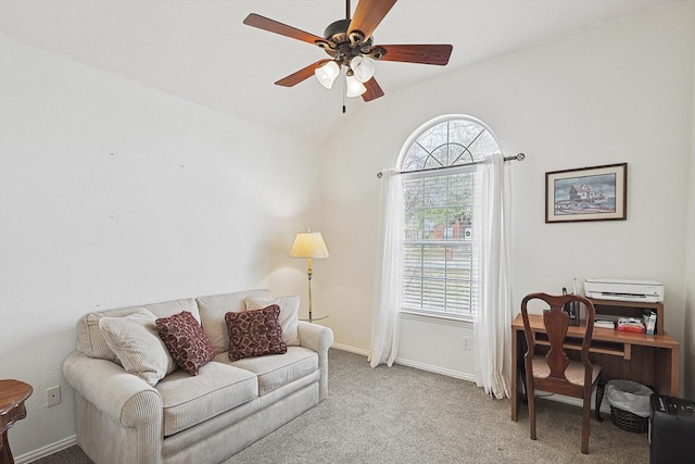 living area featuring light carpet, a healthy amount of sunlight, vaulted ceiling, and ceiling fan