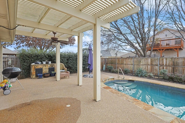 view of pool featuring exterior kitchen, a patio, ceiling fan, and a pergola