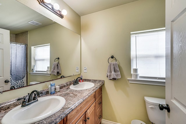 bathroom featuring toilet and vanity