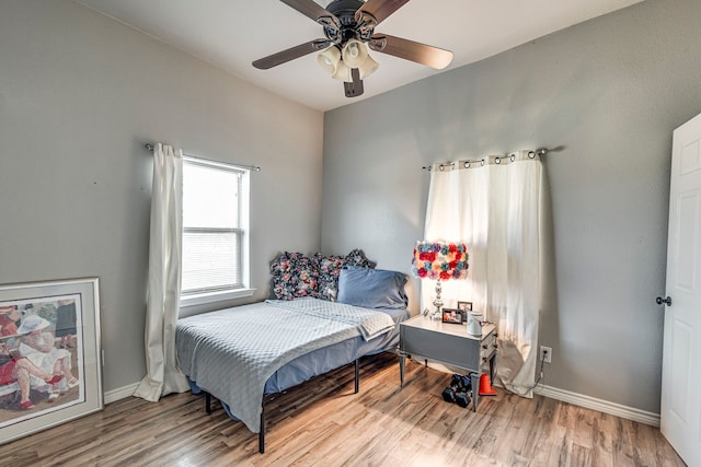 bedroom with ceiling fan and light hardwood / wood-style floors