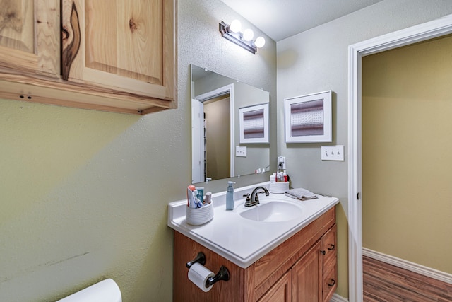 bathroom with hardwood / wood-style flooring and vanity