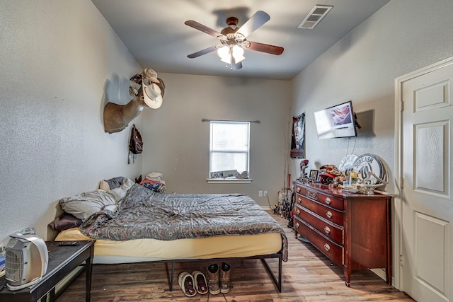 bedroom featuring ceiling fan and light hardwood / wood-style floors