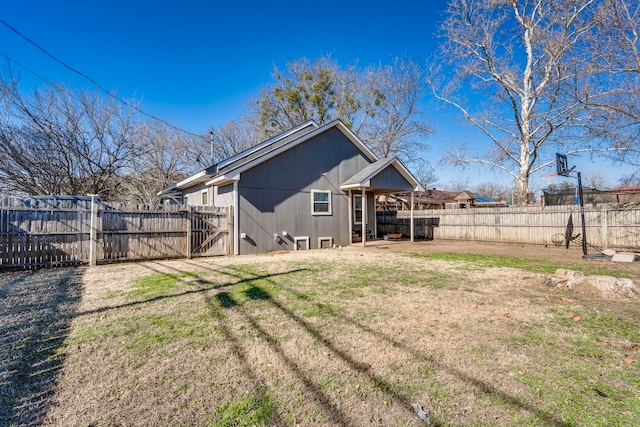 rear view of property with a yard