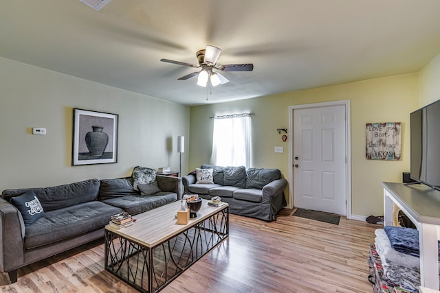 living room with ceiling fan and light hardwood / wood-style flooring