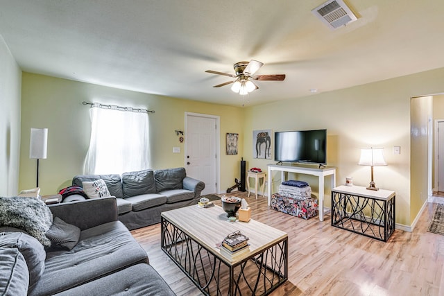 living room featuring ceiling fan and light wood-type flooring