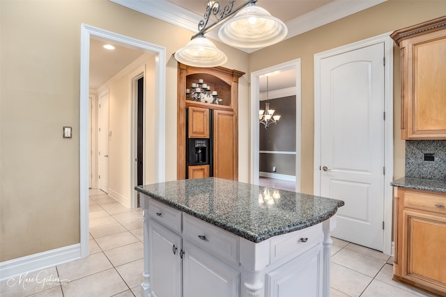 kitchen featuring white cabinetry, light tile patterned floors, a center island, and ornamental molding