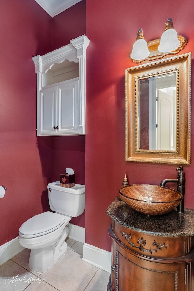 bathroom featuring toilet, ornamental molding, tile patterned floors, and vanity