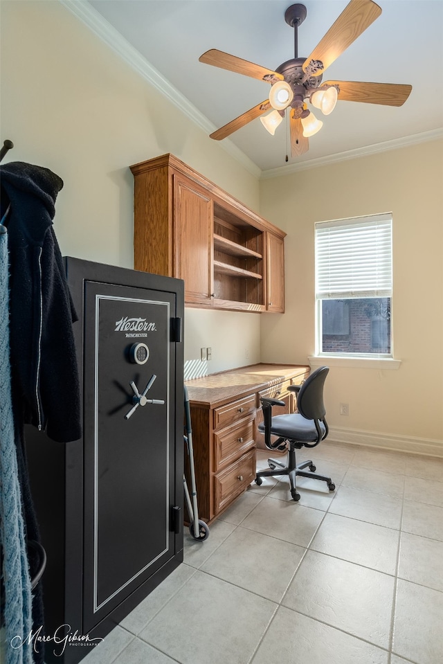 office featuring crown molding, light tile patterned floors, built in desk, and ceiling fan