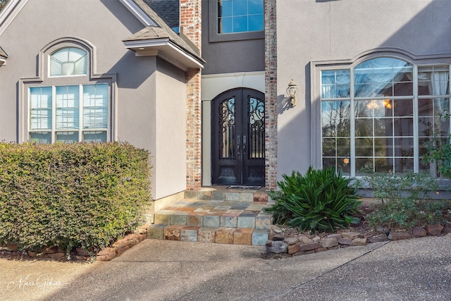 1069 Waters Edge Cir, Shreveport, LA 71106 - property entrance with stucco siding, french doors, and roof with shingles