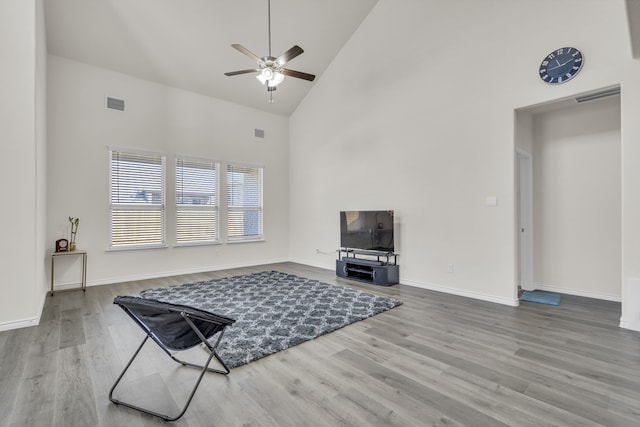 living room with high vaulted ceiling, hardwood / wood-style flooring, and ceiling fan