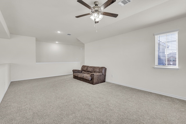 living area with carpet and ceiling fan