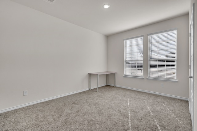 unfurnished room featuring light carpet