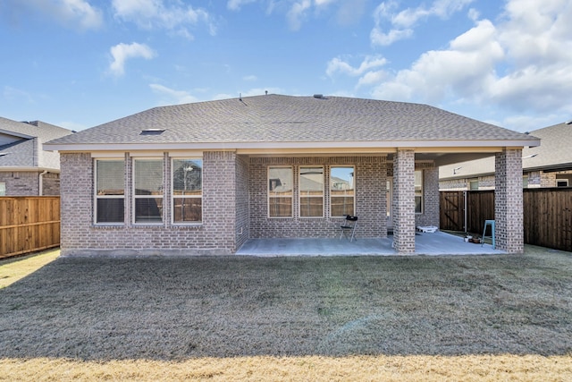 back of house featuring a patio area and a yard