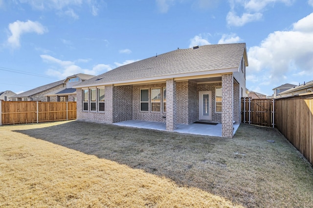 rear view of property with a patio area and a lawn