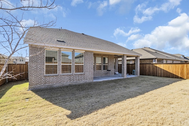 back of property featuring a patio area and a yard