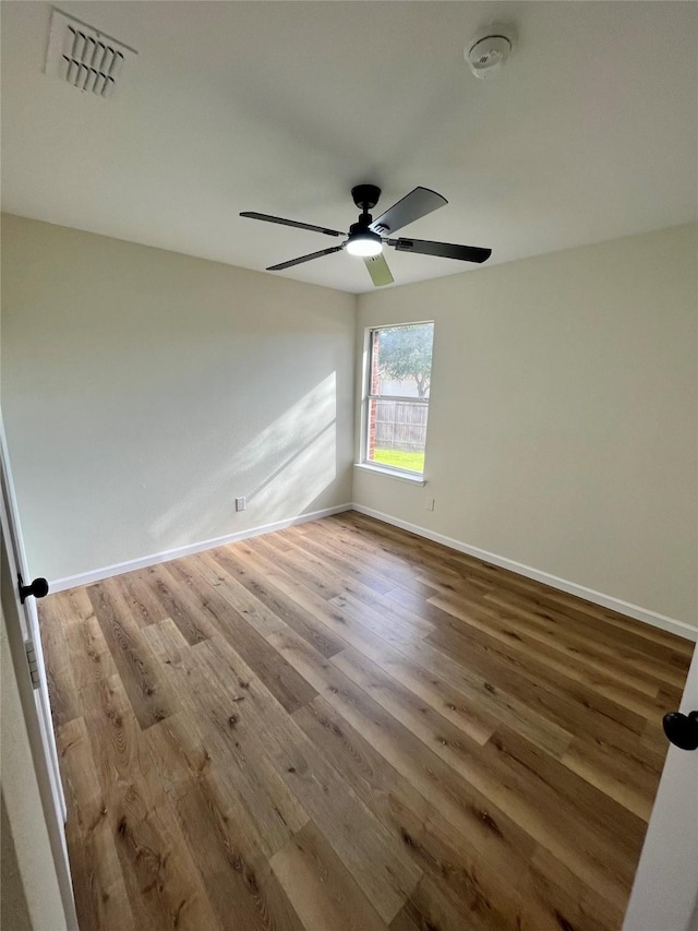 spare room featuring light wood-type flooring and ceiling fan