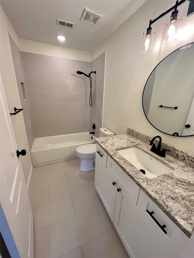 full bathroom featuring toilet, tiled shower / bath combo, tile patterned floors, and vanity