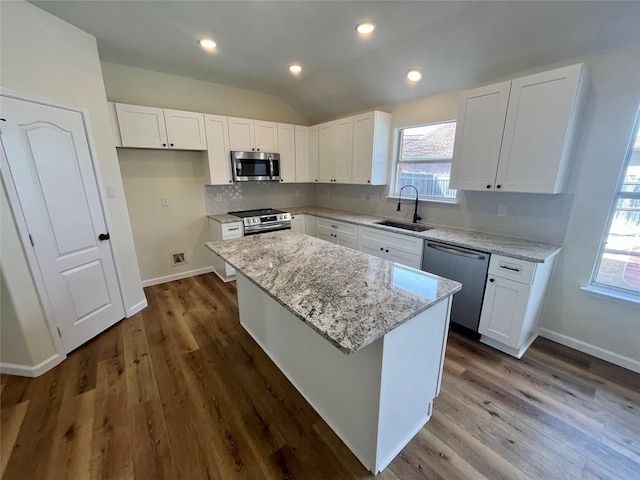 kitchen with sink, white cabinetry, appliances with stainless steel finishes, and a kitchen island