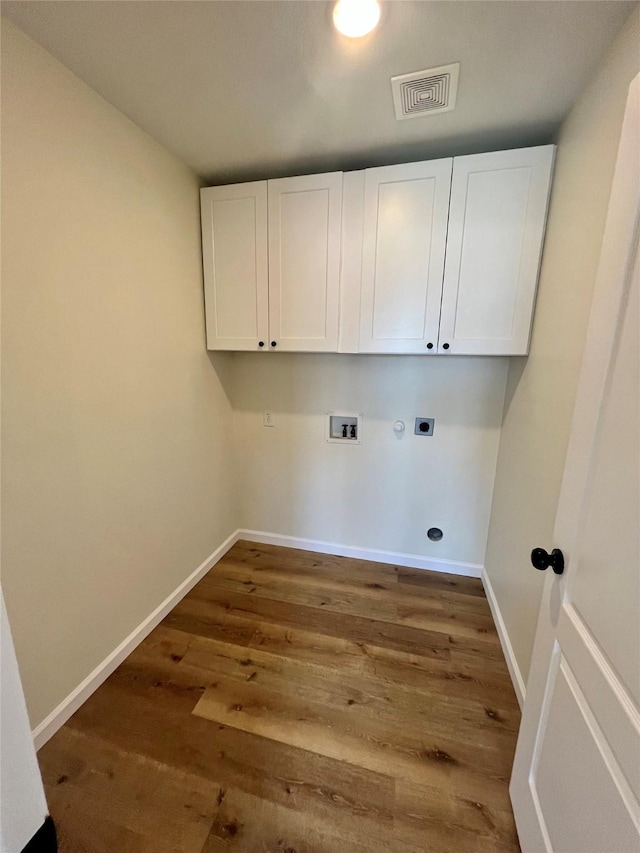 washroom featuring washer hookup, cabinets, dark hardwood / wood-style floors, and hookup for an electric dryer