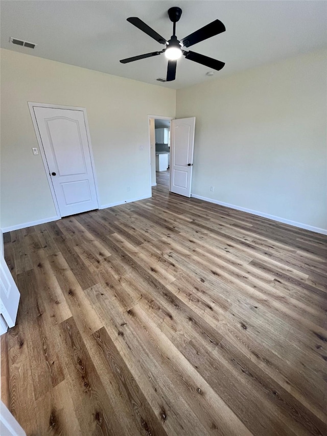 unfurnished bedroom with ceiling fan and hardwood / wood-style floors