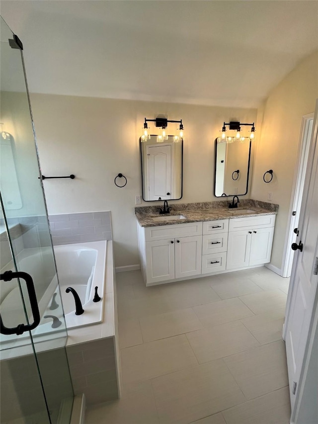 bathroom with vanity, vaulted ceiling, tile patterned floors, and shower with separate bathtub