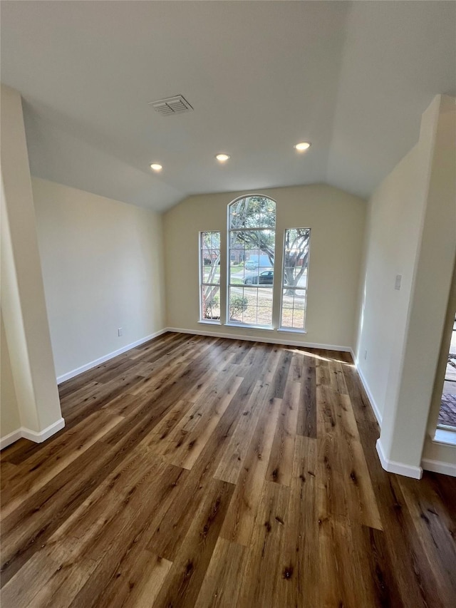 interior space with vaulted ceiling and dark hardwood / wood-style flooring