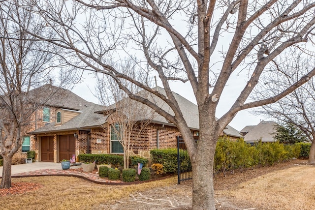 view of front of house with a garage and a front lawn