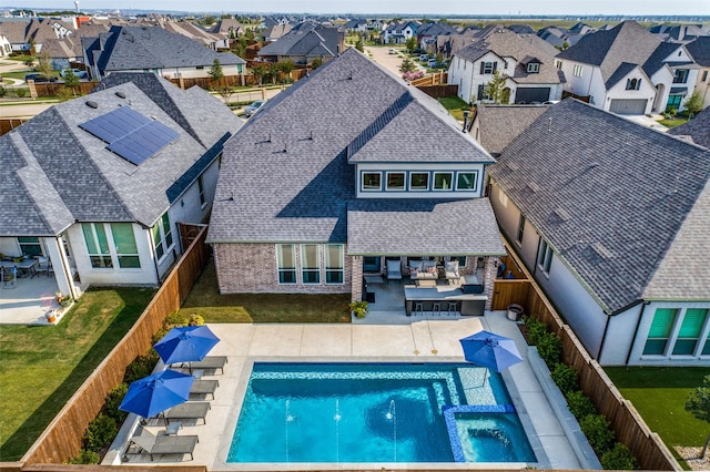 exterior space featuring a patio and an in ground hot tub