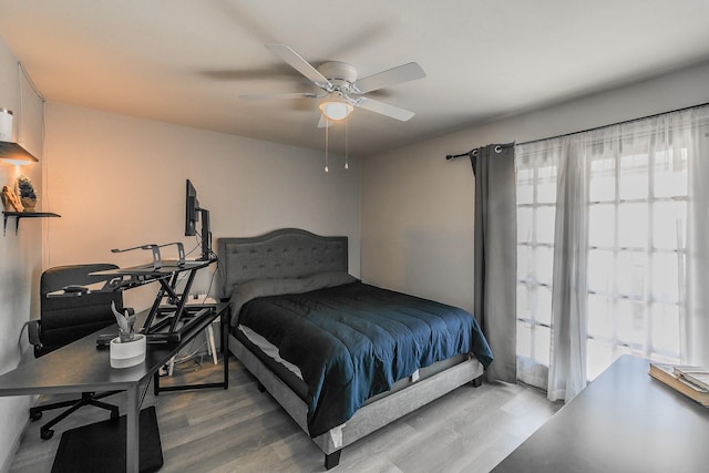 bedroom with ceiling fan and hardwood / wood-style flooring